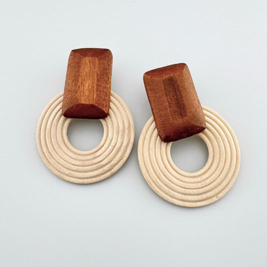 Round wooden earrings with light and brown accents.