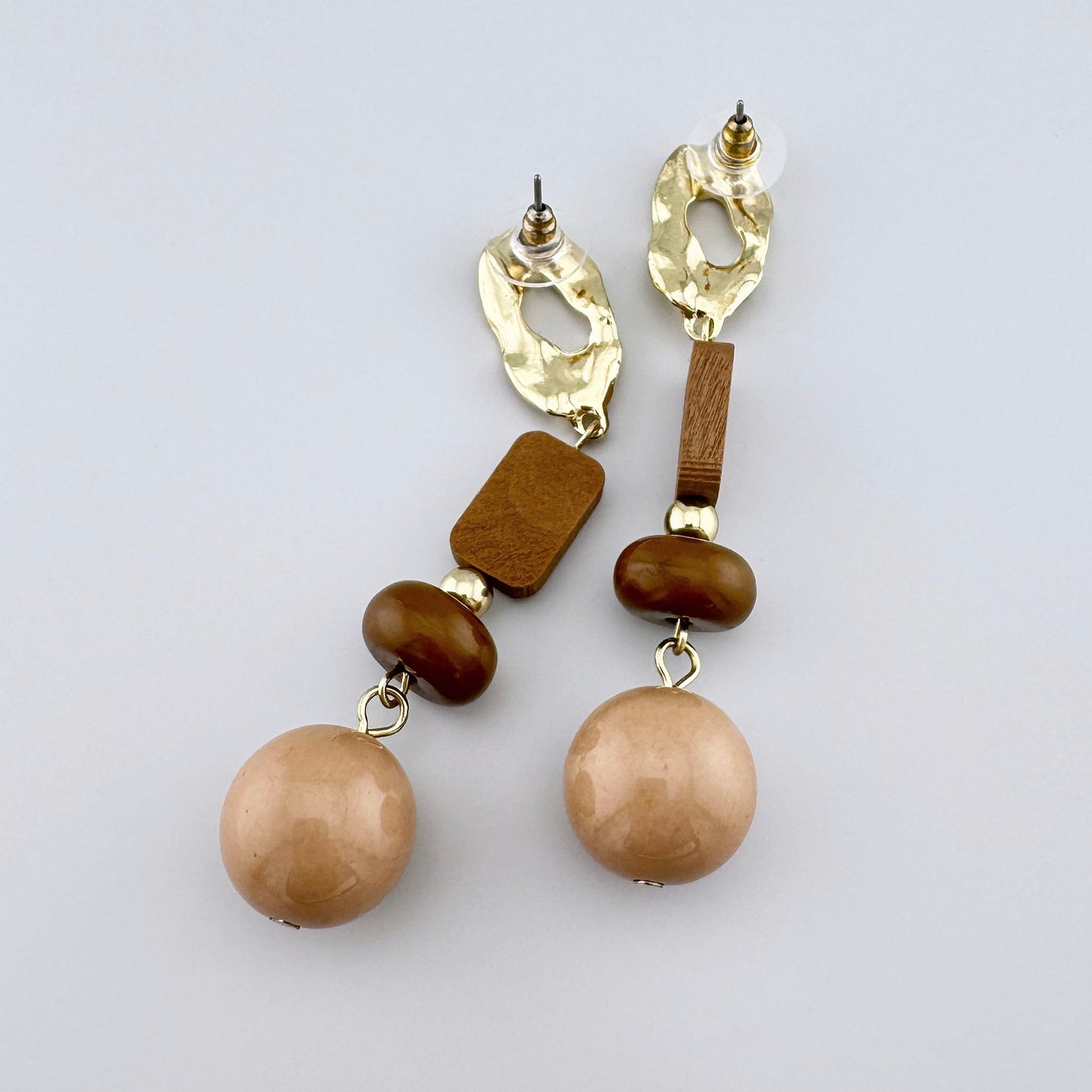 Long earrings with gold accents and brown wooden beads.