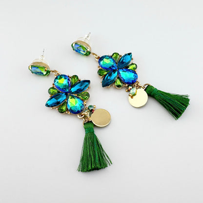 Earrings with green and blue crystals, featuring tassels and gold-tone accents.