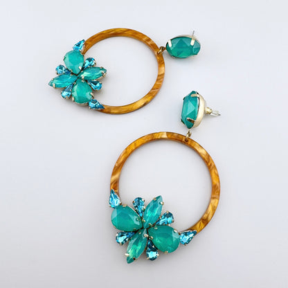 Hoop earrings with amber-like design and turquoise crystals.