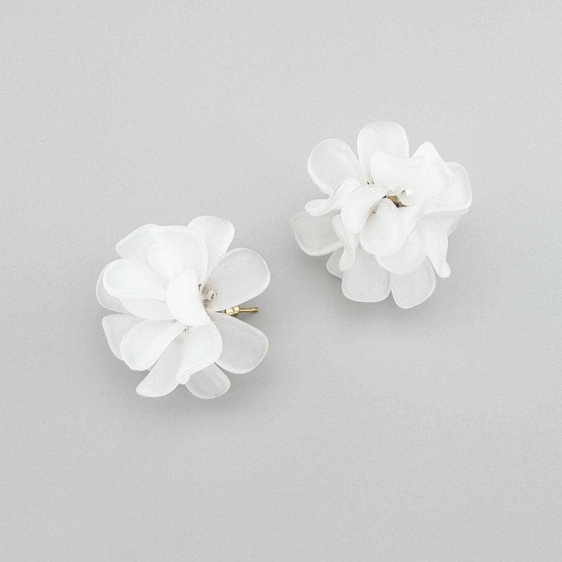 Flower-shaped earrings with multiple petals, by Spanish brand Sonata.