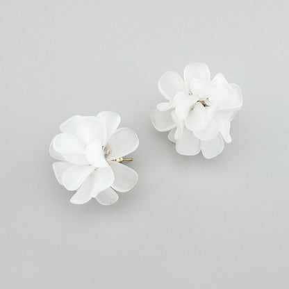 Flower-shaped earrings with multiple petals, by Spanish brand Sonata.