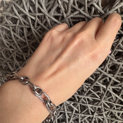 Stainless steel bracelet with a contrasting design of smooth and braided links, French brand Ikita.