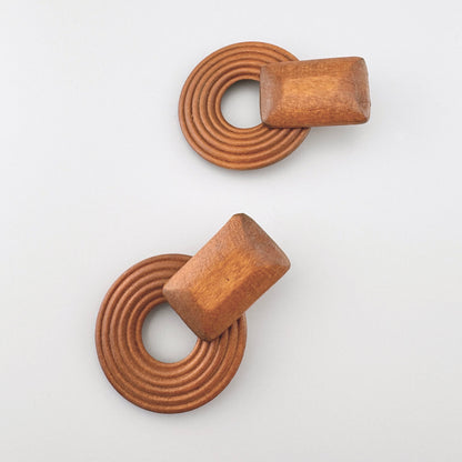 Wooden earrings in the shape of rings with a natural brown finish.