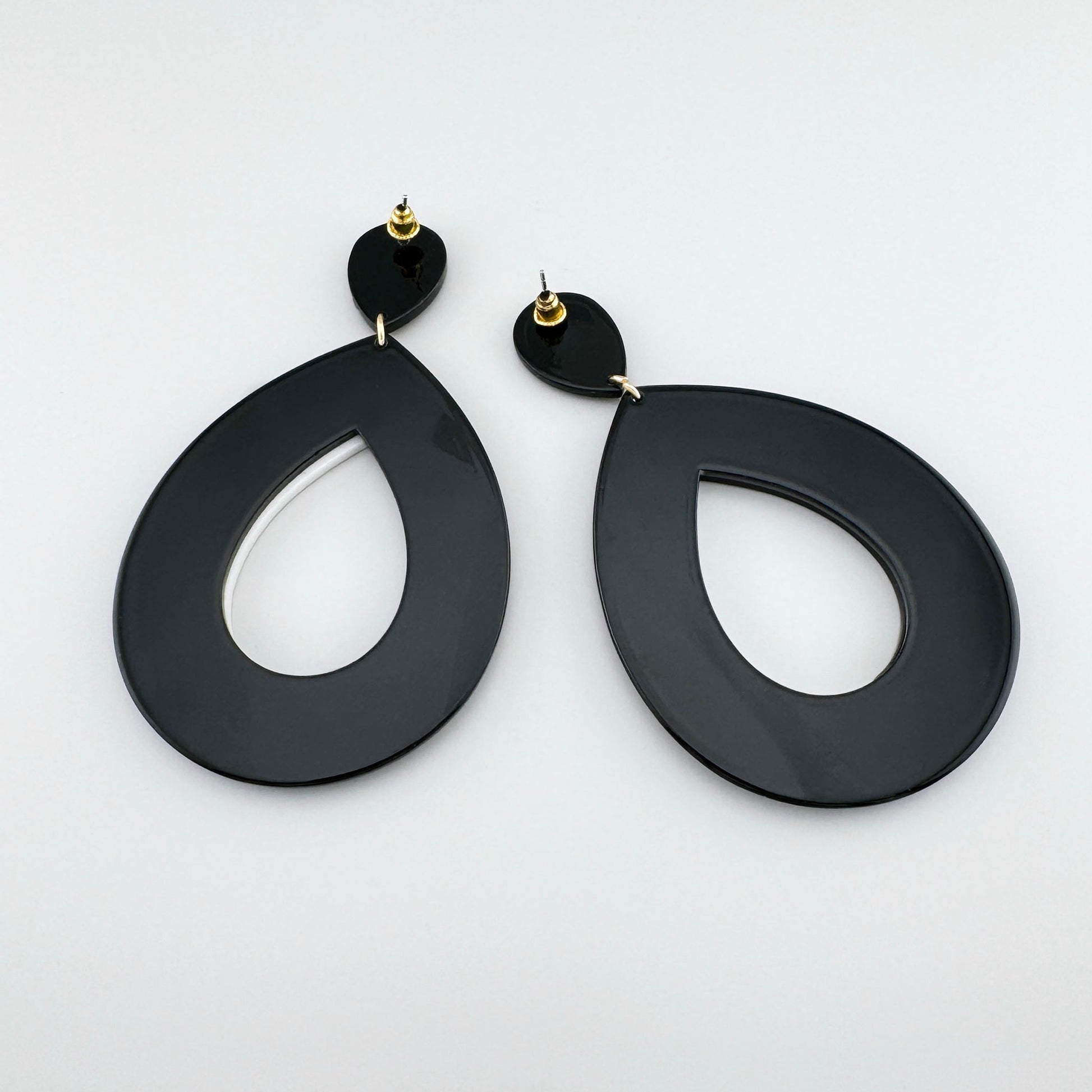 Black and white teardrop-shaped earrings with a bold contrast design.