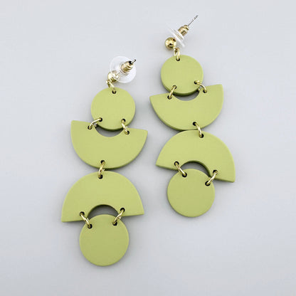 Geometric light green earrings with gold-tone connectors.