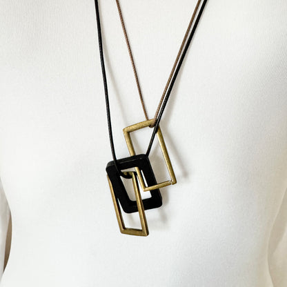 Necklace with beige and black leather cords and geometric pendants made of metal and wood, Spanish brand Sonata.