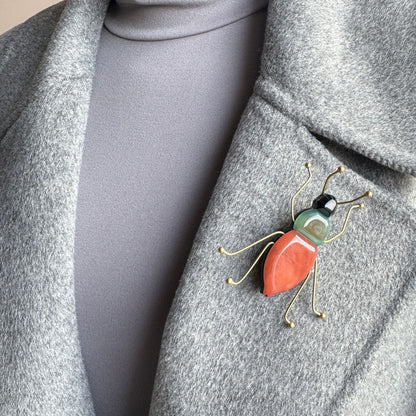 Brooch shaped like a stylized insect made of colored acrylic and gold-toned metal, Spanish brand Sonata.