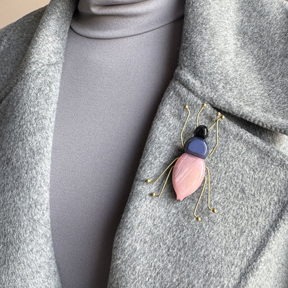 Brooch in the shape of a stylized beetle with a pink and navy acrylic body, Spanish brand Sonata.