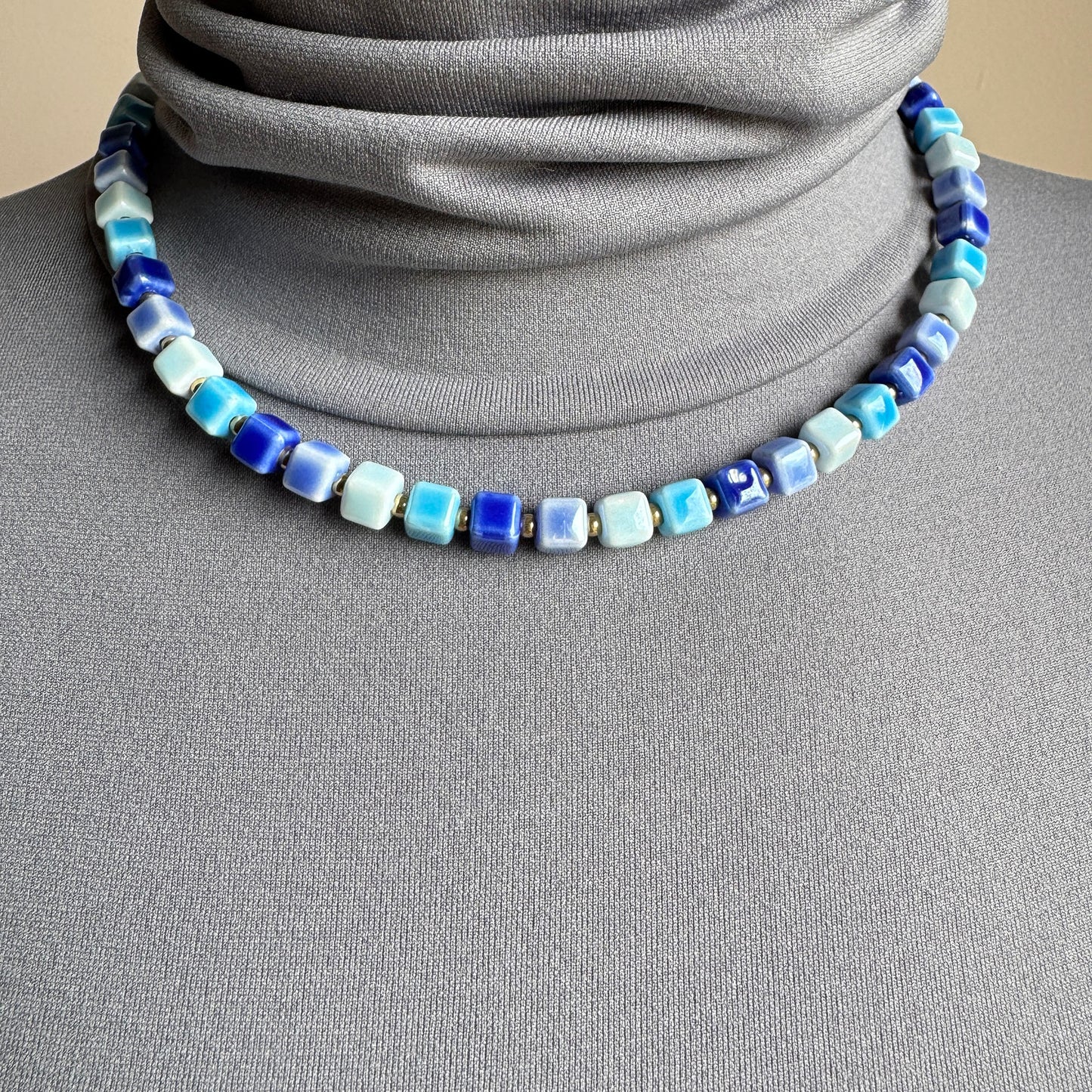 Necklace with glossy blue ceramic cubes, French brand Ikita.