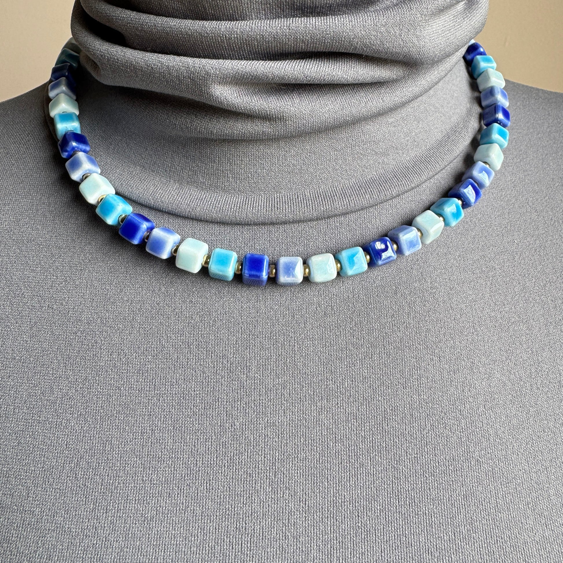 Necklace with glossy blue ceramic cubes, French brand Ikita.