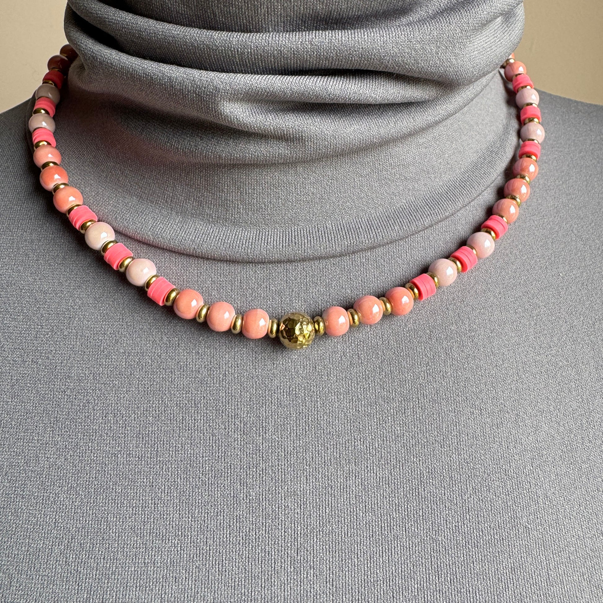 Necklace with pink pearl-like ceramic beads and a central gold accent, French brand Ikita.