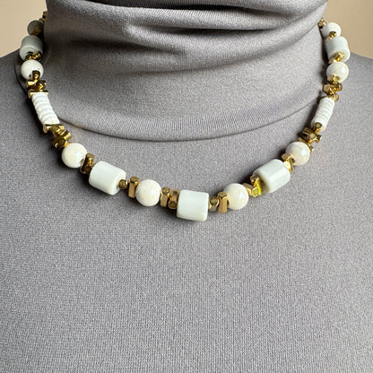 White ceramic bead necklace with golden accents, French brand Ikita.