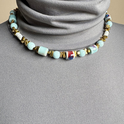 Necklace with blue ceramic beads, white discs, and gold spacers, French brand Ikita.