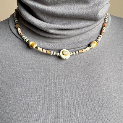 Necklace with pastel ceramic beads and a central accent, finished with gold spacers, French brand Ikita.