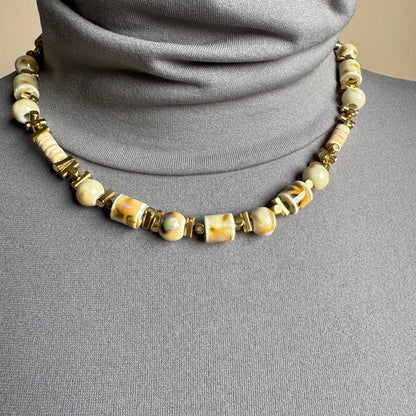 Beige ceramic bead necklace with gold-tone details, French brand Ikita.