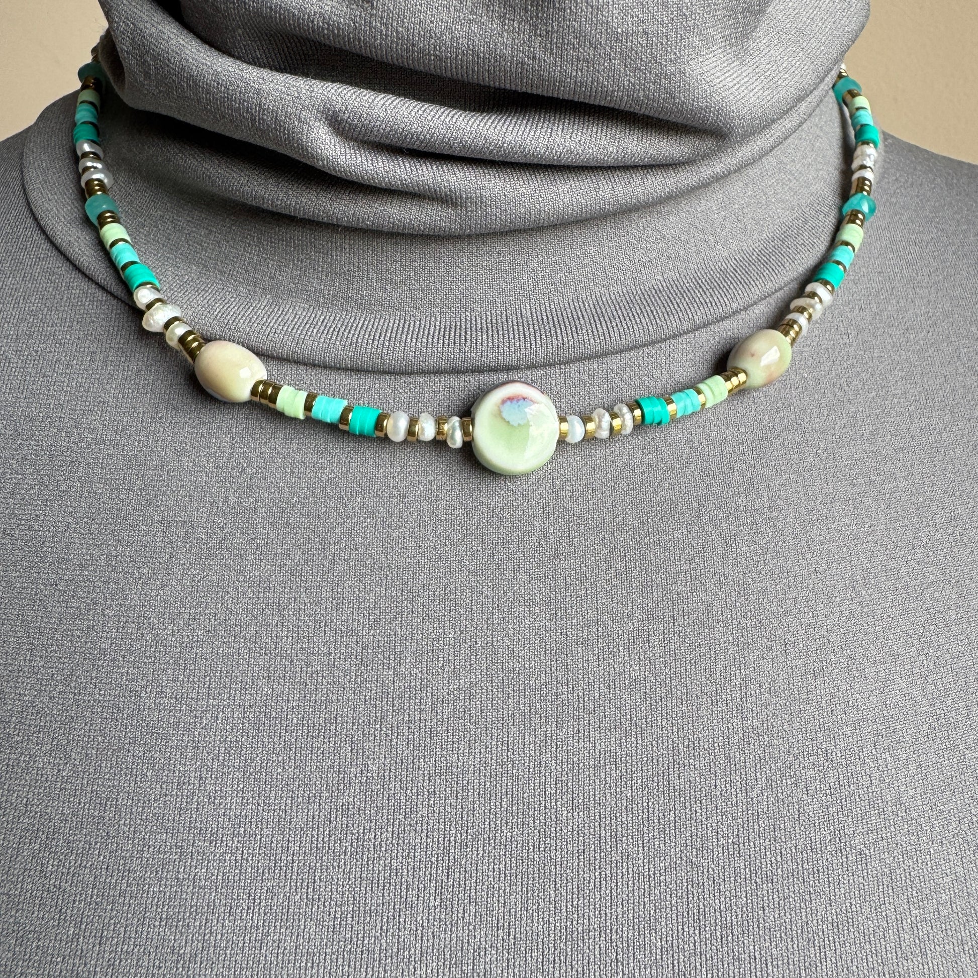 Necklace with pastel ceramic beads in mint, turquoise, and blue tones, French brand Ikita.