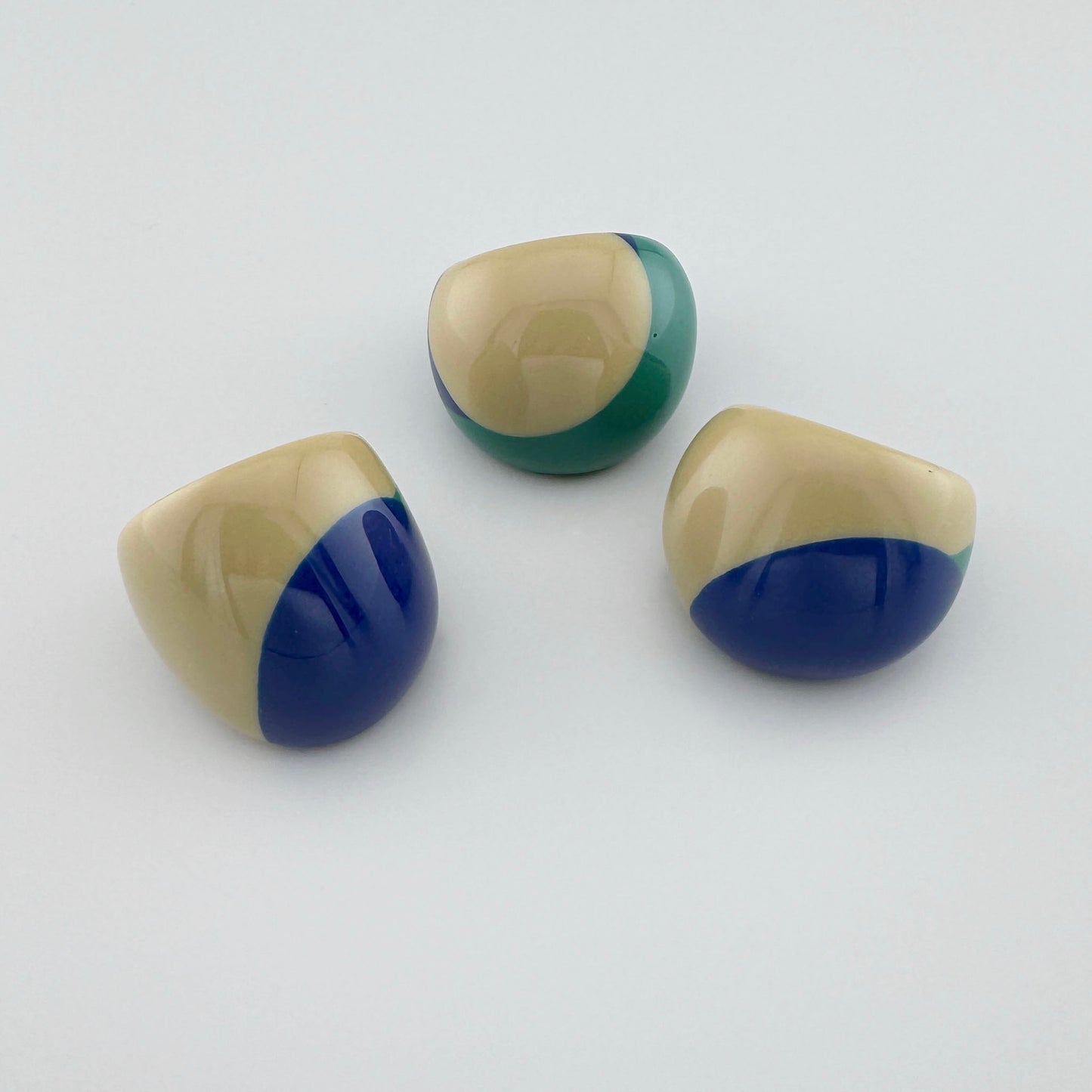 Asymmetric ring combining beige, green, and deep blue colors.