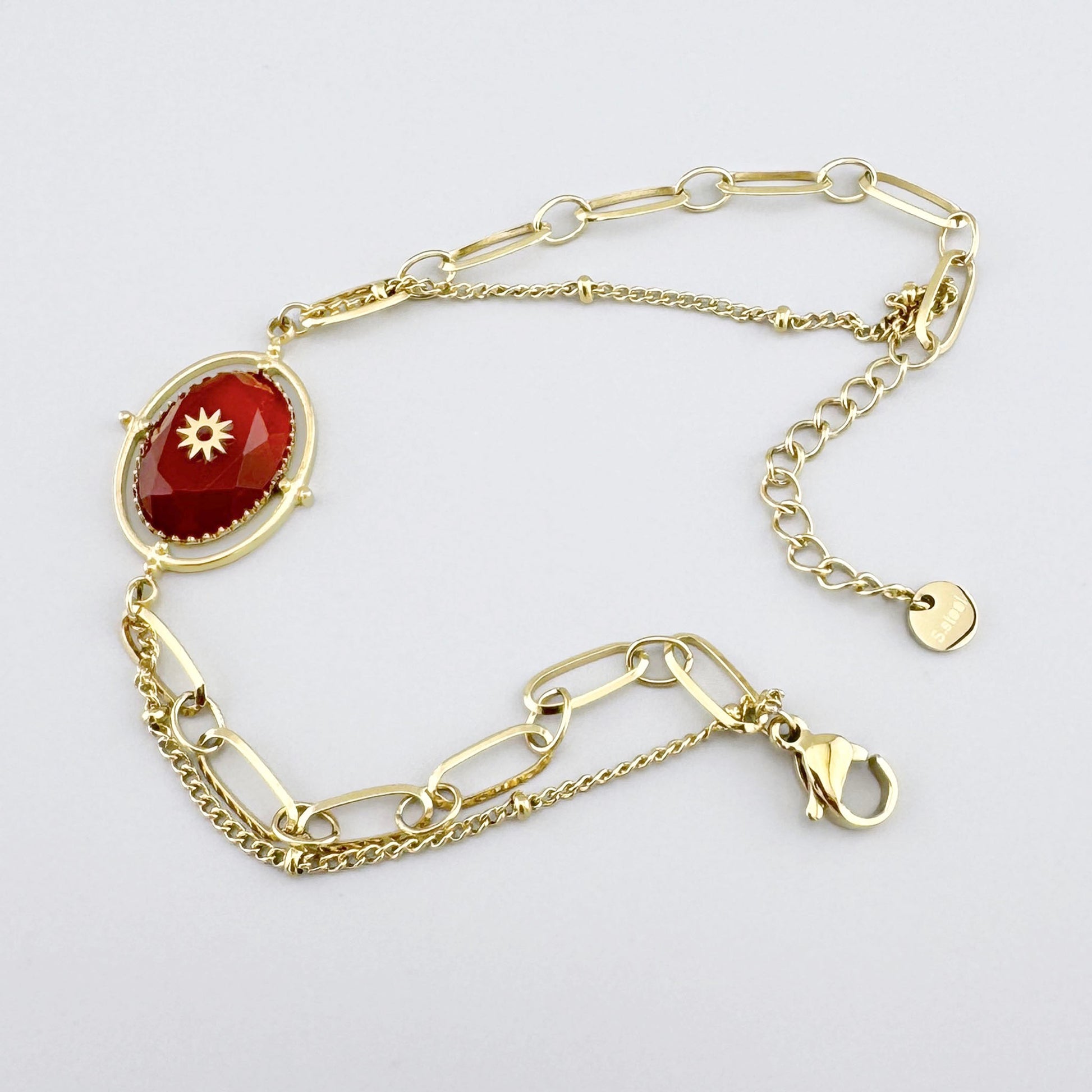 Gold bracelet with natural red carnelian, decorative design with adjustable chain.