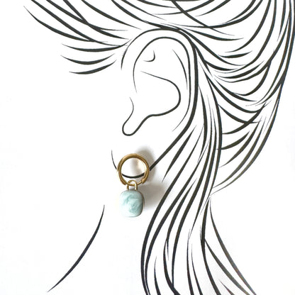 Gold hoop earrings with light blue marble-effect charms, French brand Cannelle.