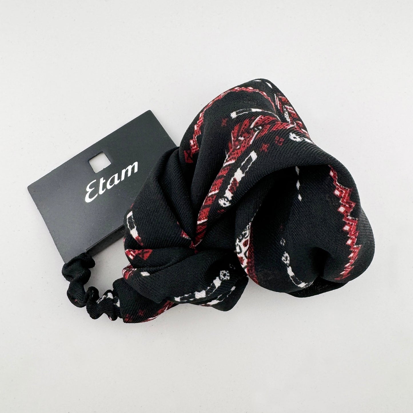 Headband made of black fabric with a red and white pattern, brand Etam.