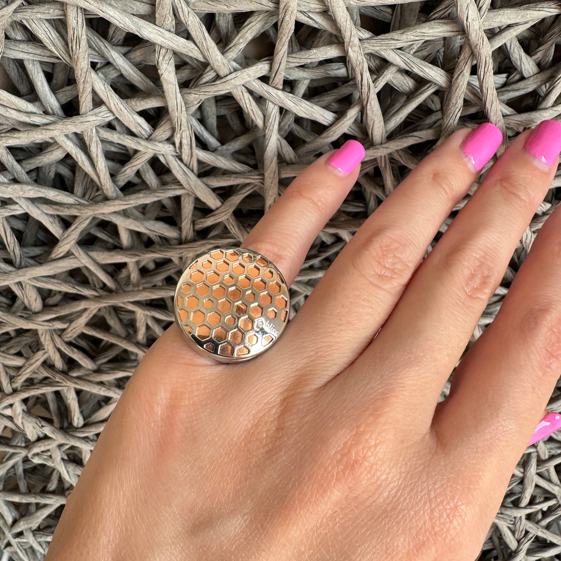 Luxurious signet ring with hexagonal pattern and warm rose gold sheen