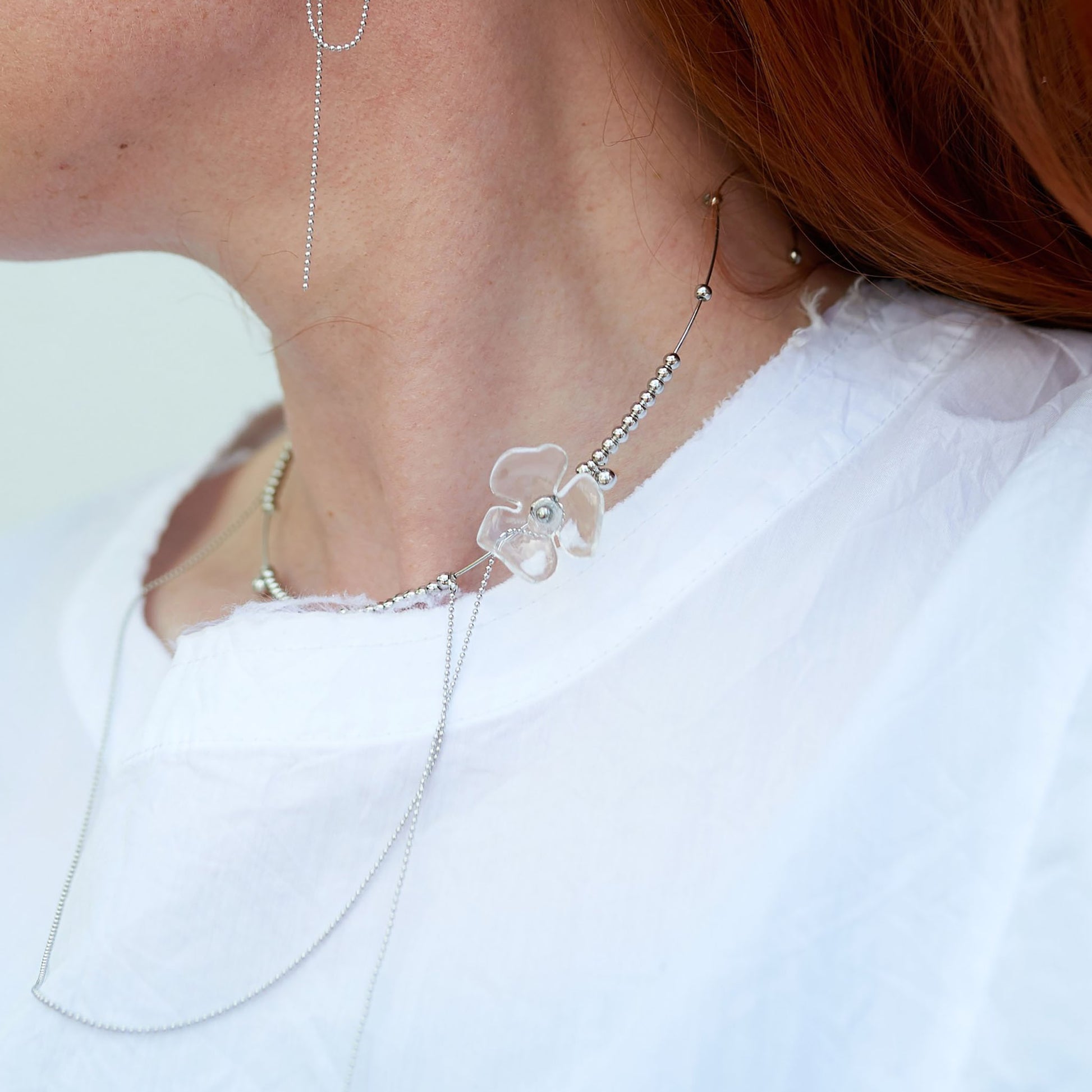 Necklace with metal beads and a transparent flower-shaped pendant, Spanish brand Maravillas.