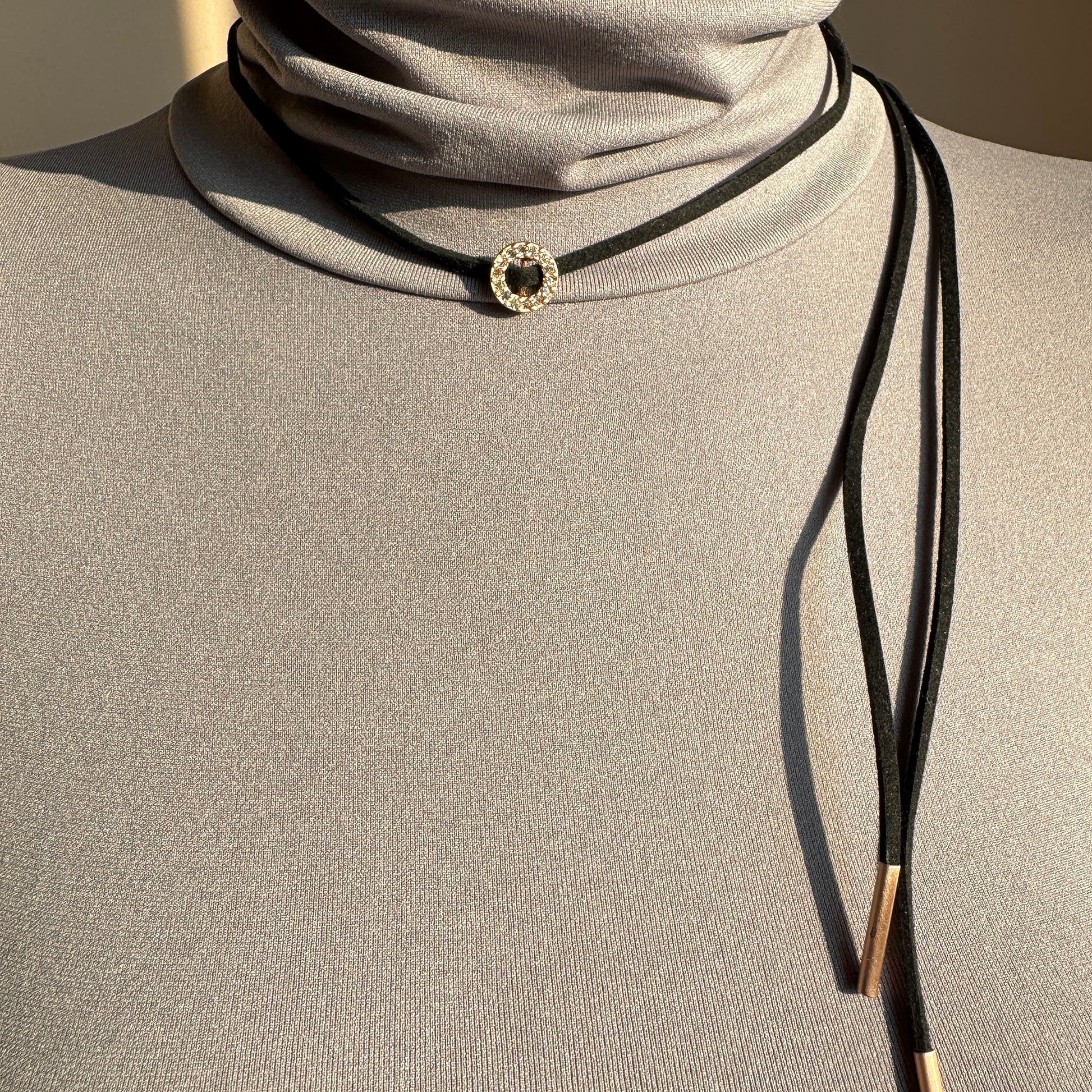 Choker Pilgrim noir à cordon réglable avec anneau doré et cristaux porté élégamment