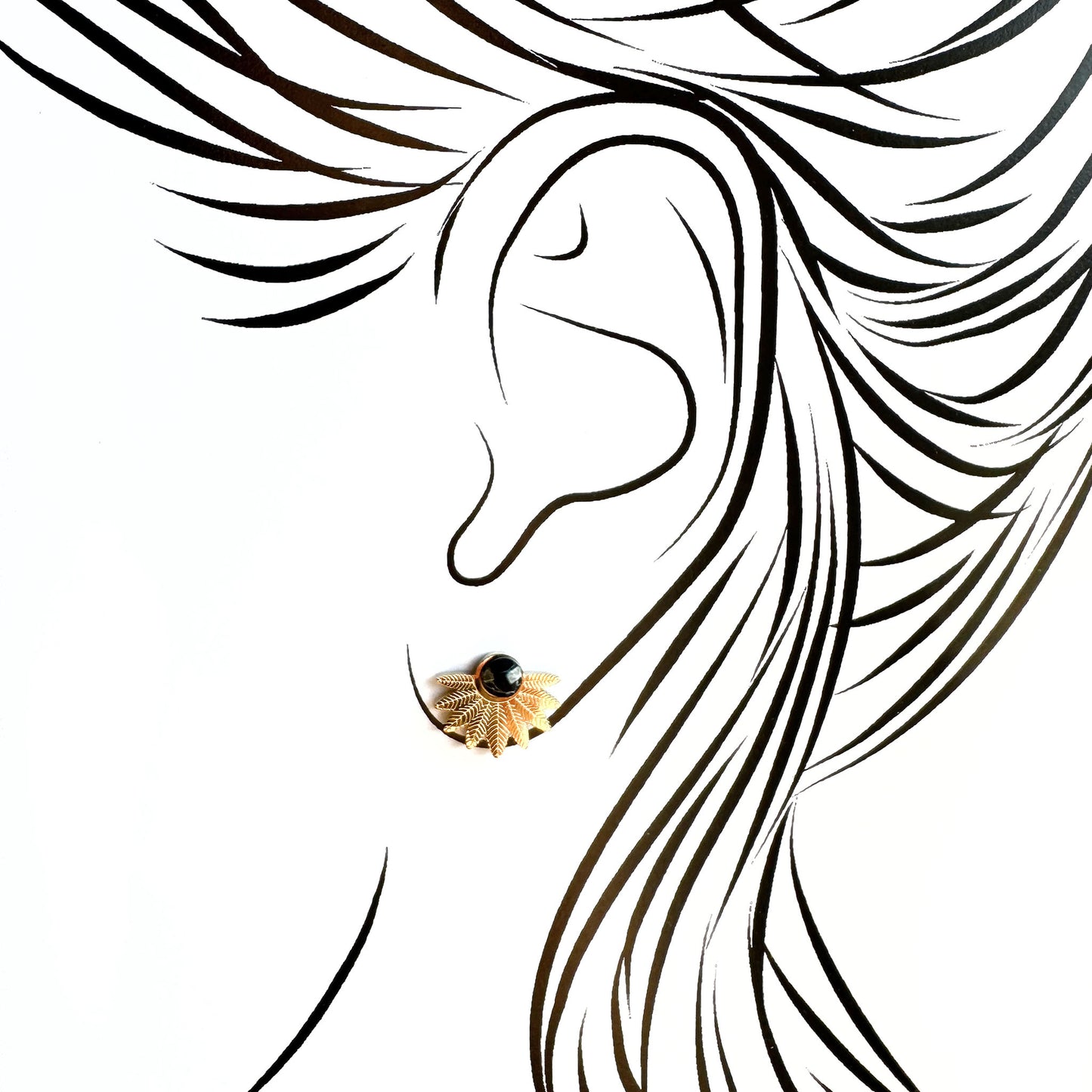 Agate stud earrings worn on ear creating a subtle modern accent