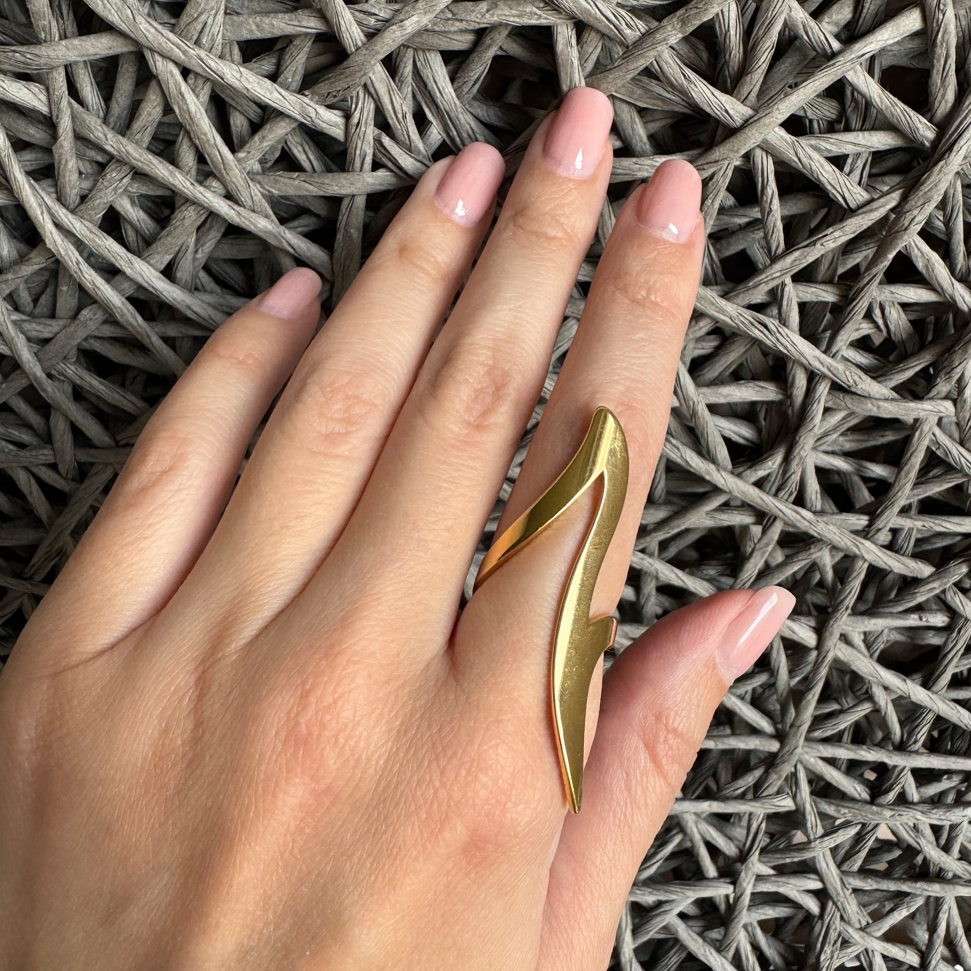 Two-tone wavy abstract ring worn on hand with sculptural modern shape