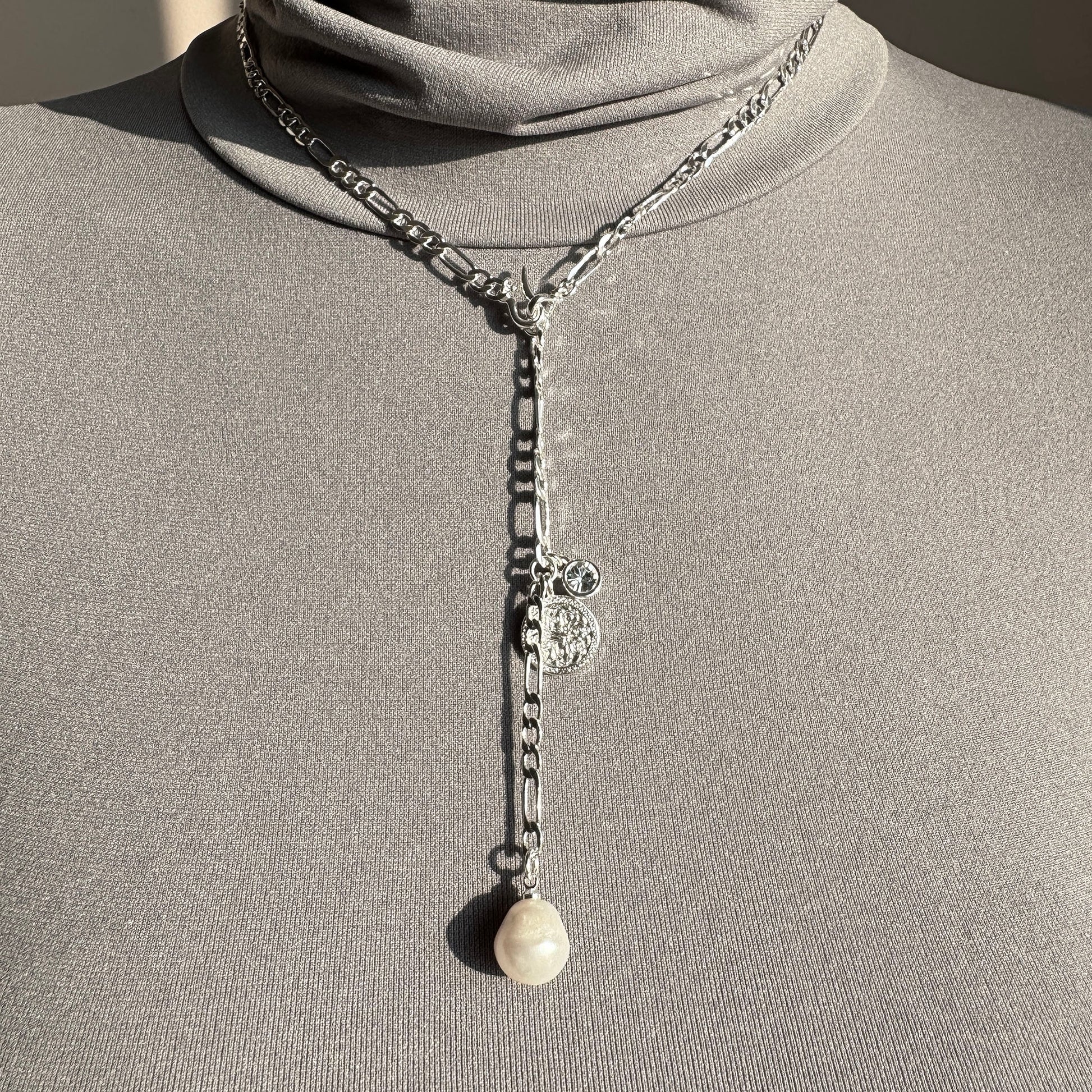 Elegant silver Pilgrim necklace with baroque pearl and medallion detail worn on neck