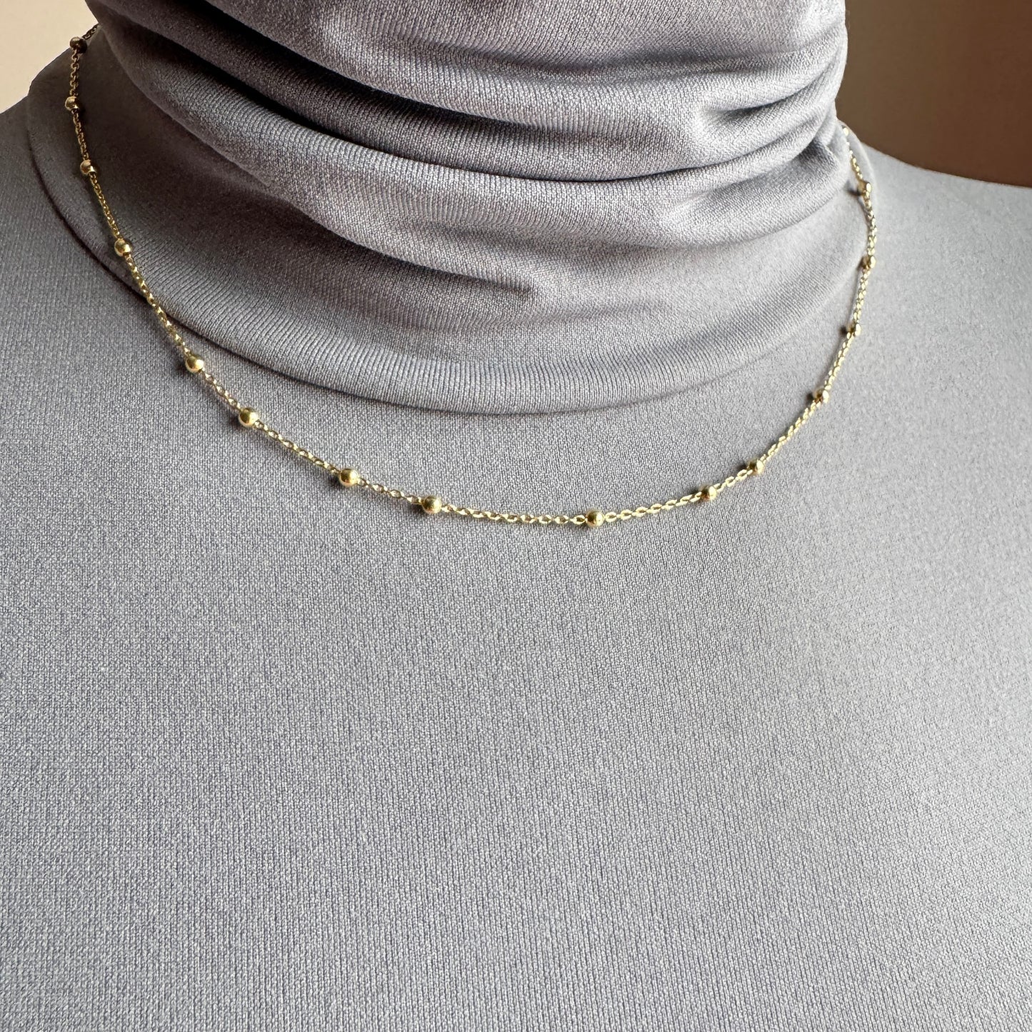 Delicate beaded necklace Universe worn close to the neck with a subtle golden shine