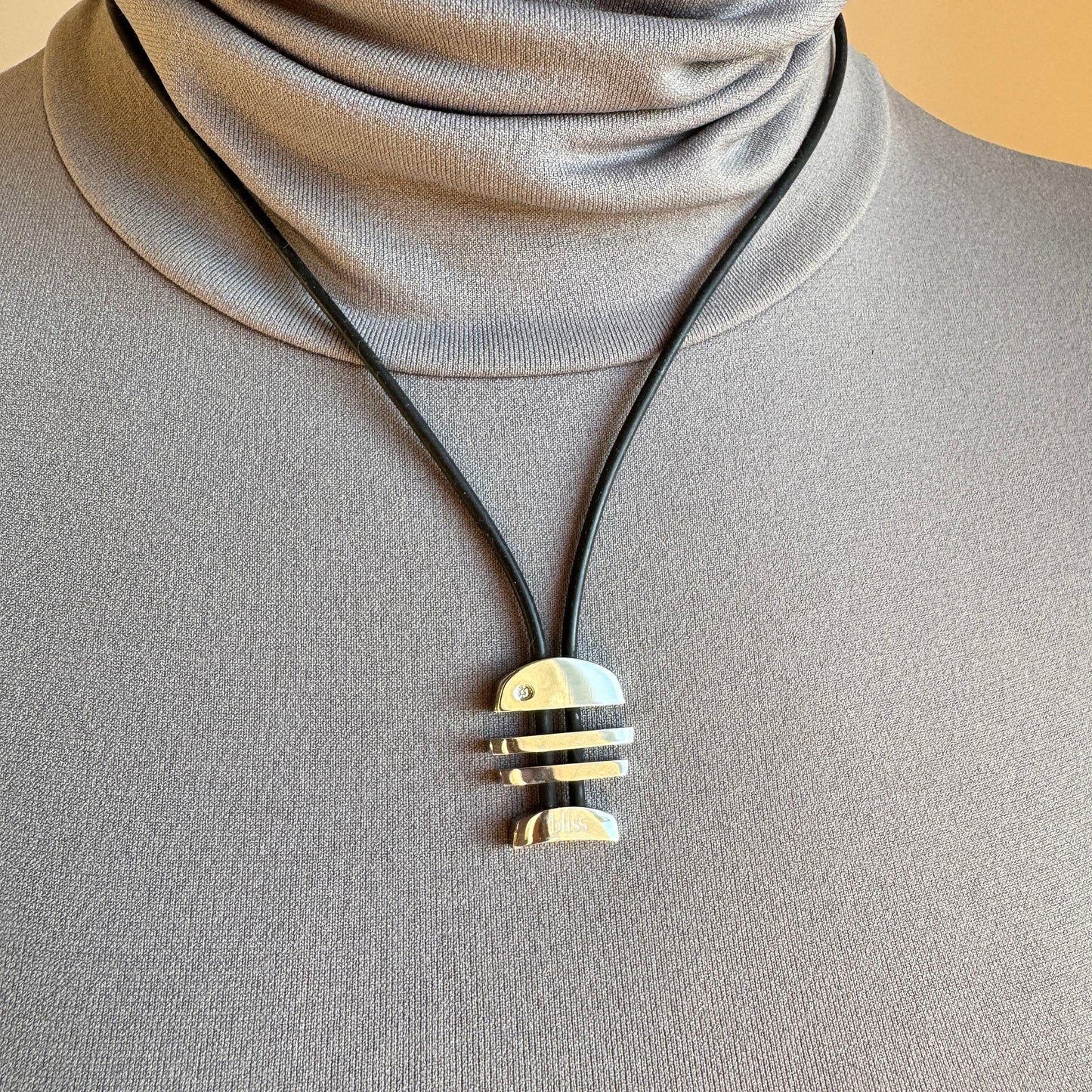 Modern geometric necklace with polished steel pendant and minimalist form