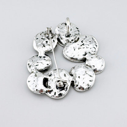 Broche Sonata avec nacre dans une monture noire et reflets irisés