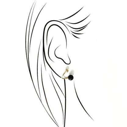 Polished gold-tone studs with a deep black stone and a spiral silhouette by Pilgrim, refined for daily wear
