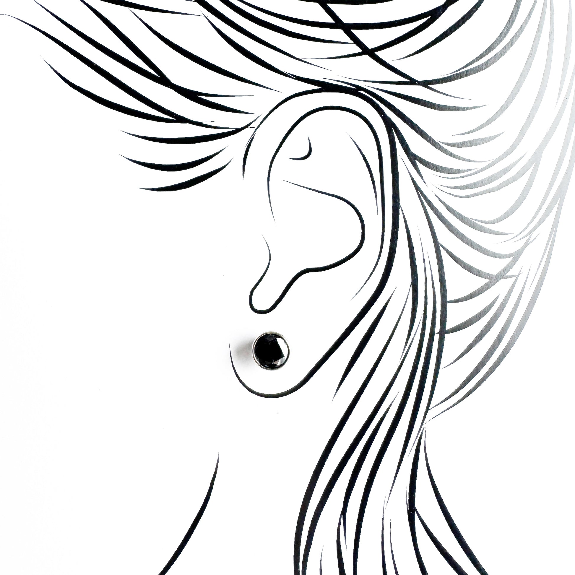 Silver black stud earrings Universe worn on the ear with a polished setting