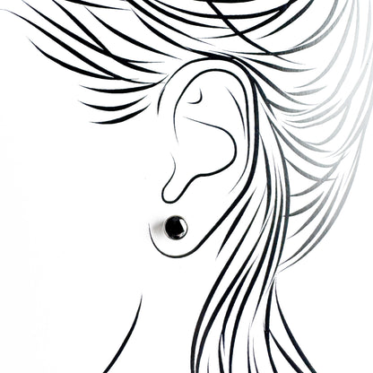 Silver black stud earrings Universe worn on the ear with a polished setting