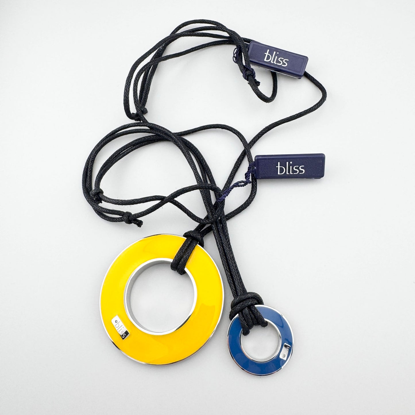 Reversible enamel necklace showing yellow and blue pendant elements together