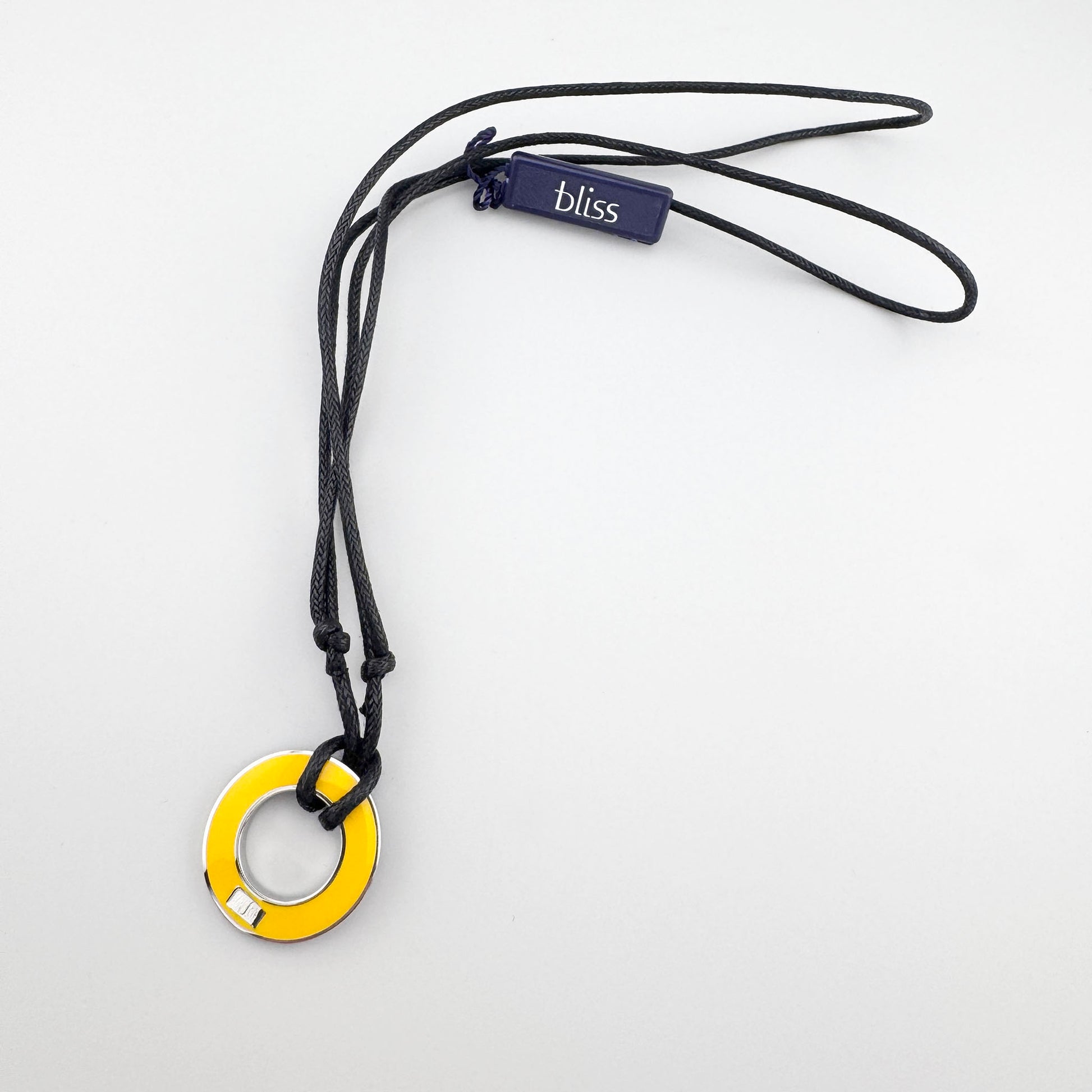 Collier réversible en émail sur cordon noir, pendentif jaune en mouvement