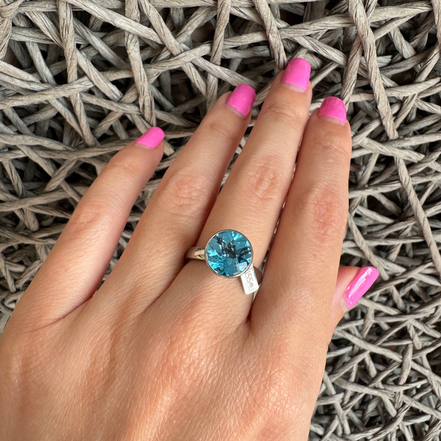 Elegant Bliss Gioielli blue topaz ring on hand with bright faceted sparkle