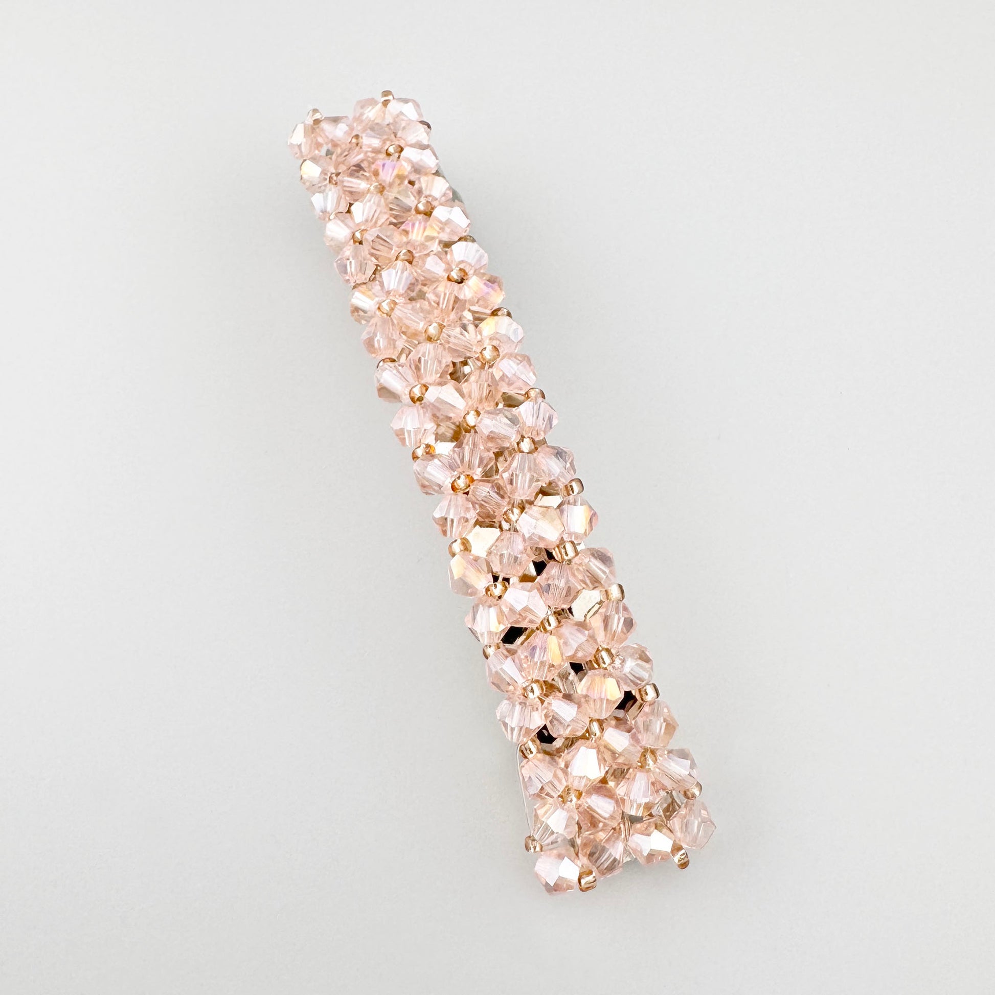 Pink crystal hair barrette with a soft shine and elegant elongated shape
