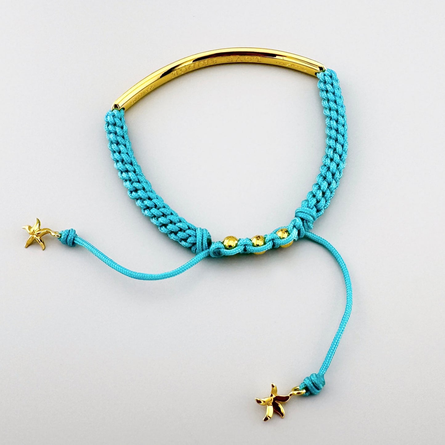 Turquoise braided bracelet Thomas Sabo with an adjustable cord and gold-tone center bar