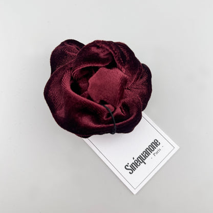 Chouchou en velours bordeaux Sinequanone plié près de son étiquette de marque