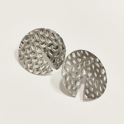 Hammered surface earrings with cut-out detail, French brand Ikita.