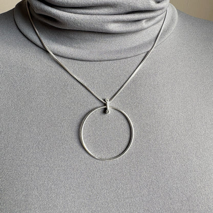 Elegant Pilgrim necklace with silver circle pendant and subtle cubic zirconia sparkle