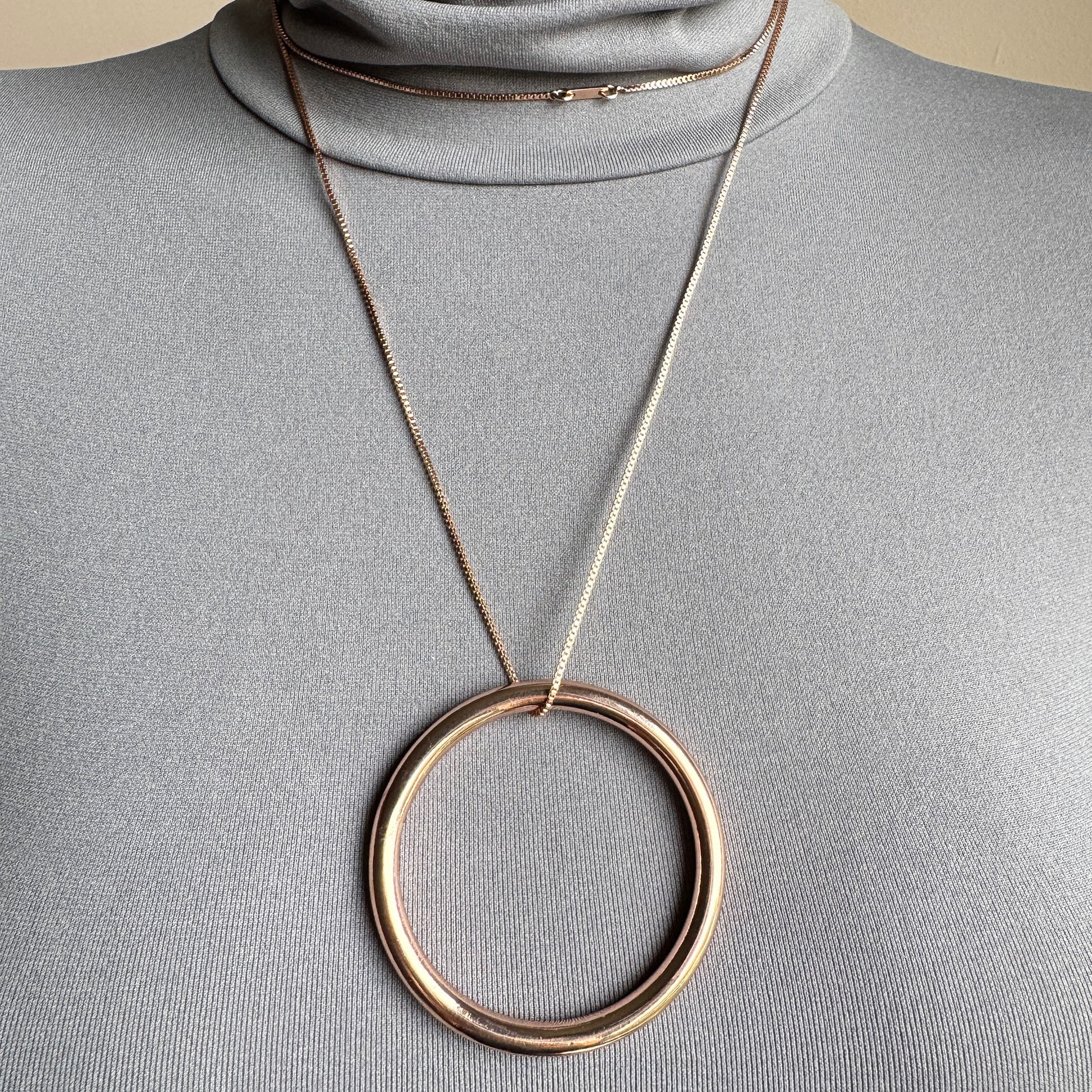 Elegant Pilgrim necklace with large circle pendant in rose gold tone on long chain