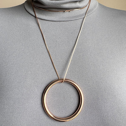 Elegant Pilgrim necklace with large circle pendant in rose gold tone on long chain