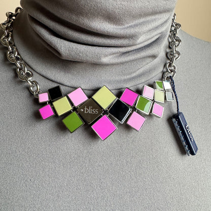 Color square necklace worn at the neck with bright geometric tiles