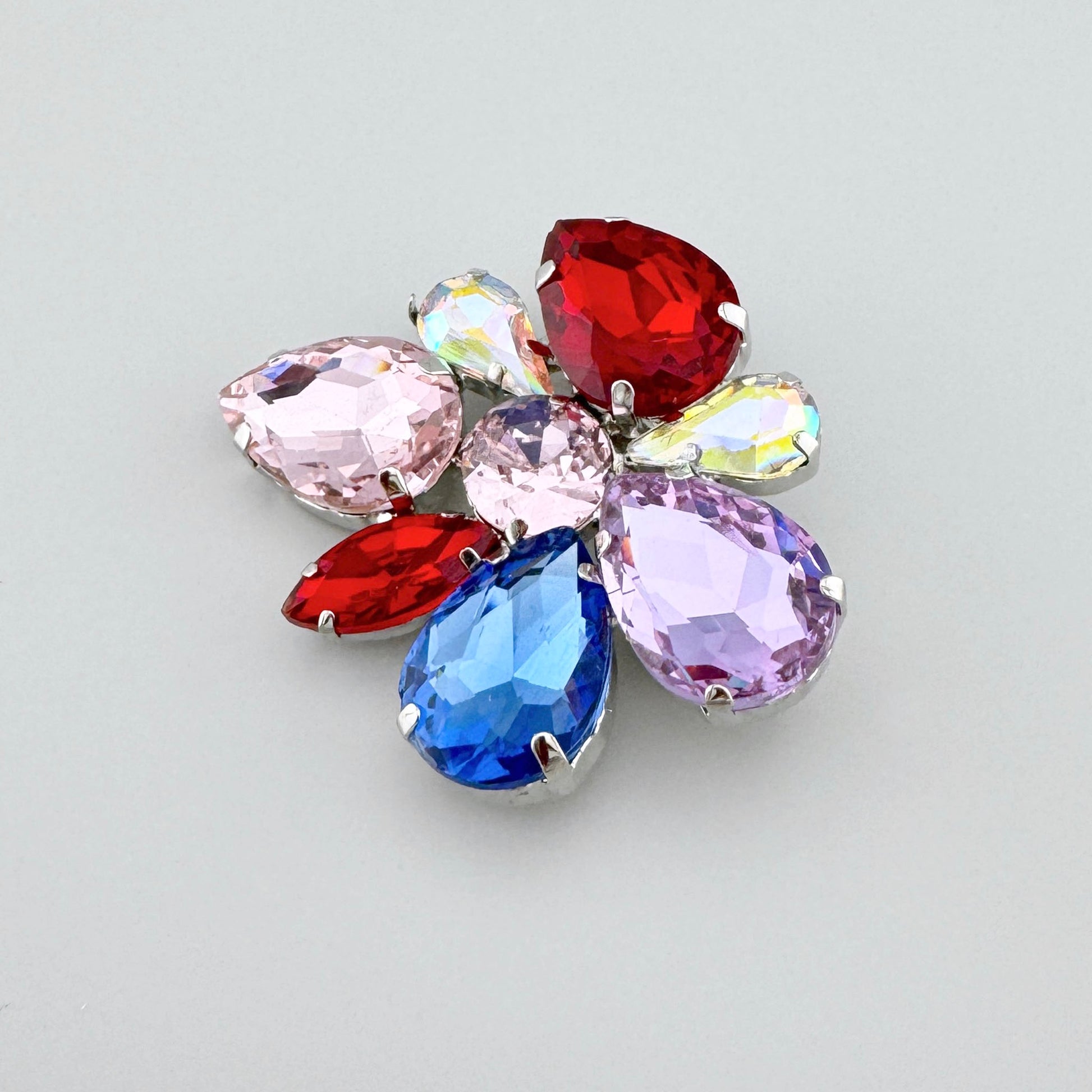 Broche flor Sonata con cristales rojos, rosas, violetas y azules en forma simétrica