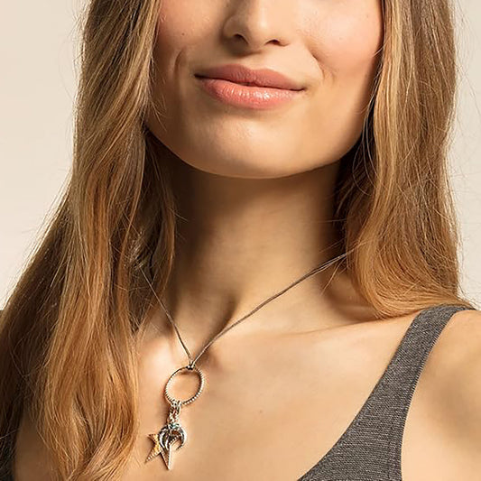 Silver crescent moon charm Thomas Sabo worn on a necklace with a turquoise accent
